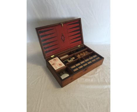 A mahogany games compendium, the hinged lid opening to reveal an interior back gammon / chess board, a cribbage board, beziqu