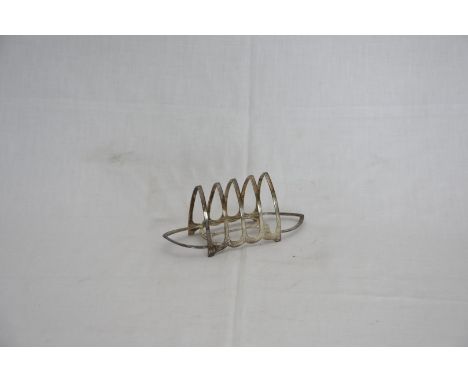 A George V silver four slice toast rack with gothic arched section.  Sheffield 1928.  Makers the Hutton Family.  