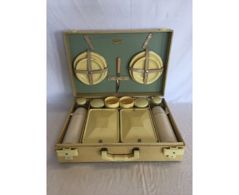 A Brexton 1930’s picnic set comprising four teacups, four saucers, four side plates, four covered pots, two flasks and two lu