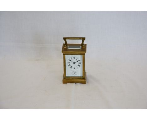 A 19th century French brass cased carriage clock by Duverdrey & Bloquel with swing handle, enamelled dial with Roman numerals