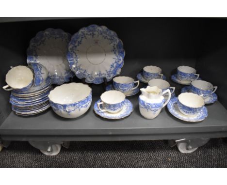 A late 19th century partial dinner service having blue floral transfer pattern on white ground, with fluted edges, included a