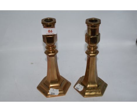 A pair of interesting antique brass candlesticks, W M and S etched to faceted side, appear to have been converted from a prio
