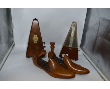 Two vintage wooden metronomes, one French with solid wood case, circa 1930s and the other German with plastic window to front