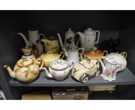 A mixed lot of vintage and antique tea and coffee pots, including novelty racing car, Beleek and Hornsea pottery 'Cornrose'.