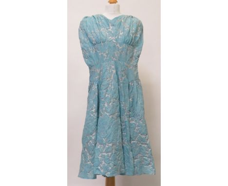 A 1950's/1960's evening dress in light blue/silver embossed nylon, the sleeveless dress fitted at the waist and with full ski