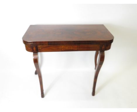 A mid 19th Century rosewood rectangular foldover swivel top card table with line inlay and fleur de lis decoration and on fou