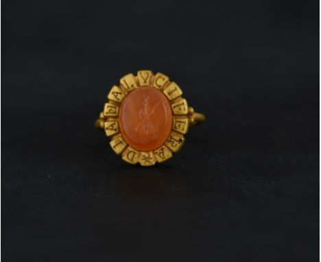 A cornelian intaglio ring, possibly Roman, carved as Diana carrying a flaming torch, the head engraved with the motto 'Diana 