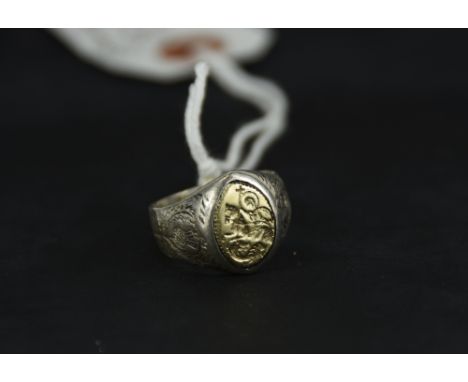 A two colour ring, the head inset with an intaglio of Saint George, the sides engraved with thistles
