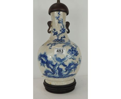 A Chinese blue & white bottle vase painted in underglaze blue with figures in pagodas in a wooded rocky landscape & with song