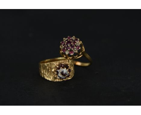 A ruby and diamond 9 carat gold cluster ring, finger size O1/2; and an unmarked garnet cluster ring; 7 g gross