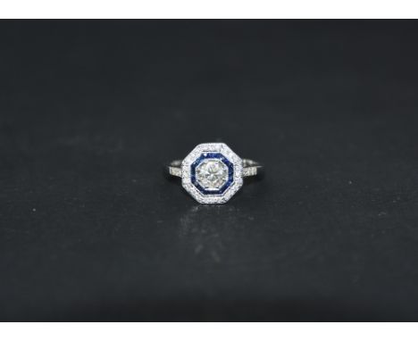 An 18ct white gold Art Deco style sapphire and diamond ring, centre diamond approximately 0.55ct