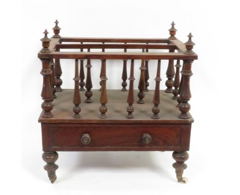 A Victorian walnut Canterbury with slender turned spindles and supports & fitted with single drawer, on original brass & cera