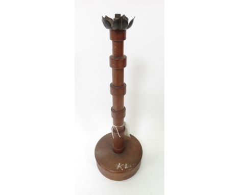 An early 20th Century oak table lamp having collared cylindrical stem on deep circular base and original metal Lotus" type to