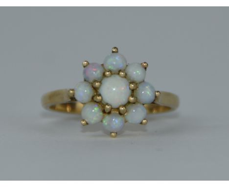 A 9ct gold nine stone opal ring, finger size O, 2.8 g gross