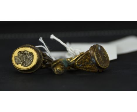 A gilded Roman style intaglio ring; with two metal ancient style rings