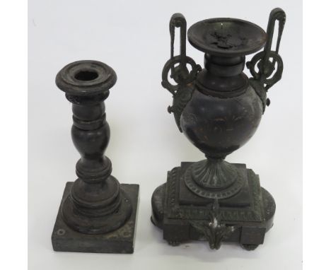 A 19th Century turned black slate candlestick together with a cast metal and black slate urn