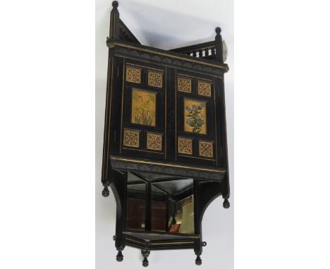 A Victorian Aesthetic movement ebonised corner wall hanging cupboard with turned pillars to the top rails, pair of panelled d