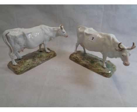 Pair of Mid 19thC Continental Cattle with white ground figures on naturalistic bases, Stamped K E to base, Height 16cm Condit