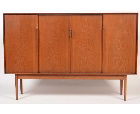 A teak sideboard, possibly by G-Plan or Dalescraft, the rectangular top above a central pair of sliding doors enclosing shelv