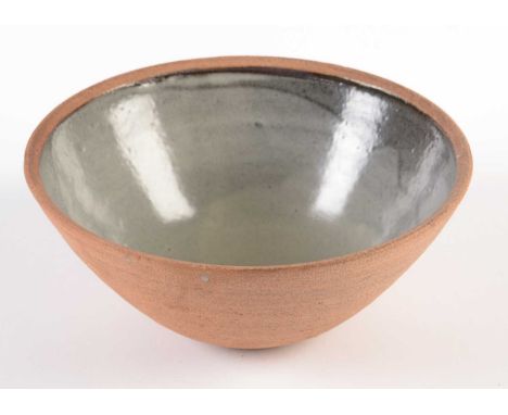 A Leach Studio pottery bowl, St Ives Cornwall, of shallow U shape in unglazed terra cotta, the interior with pale blue/grey g