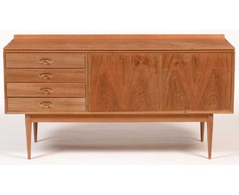 Robert Heritage for Archie Shine: a teak Hamilton pattern sideboard, fitted four long fluted drawers, a pair of cupboard door