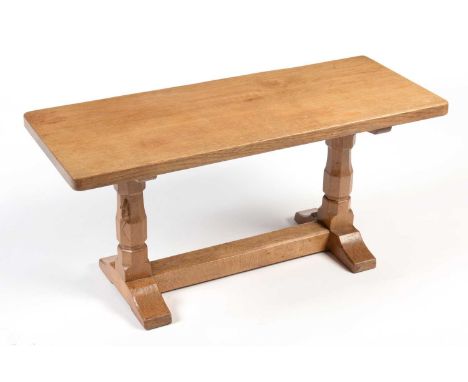 Workshop of Robert 'Mouseman' Thompson (Kilburn): an oak coffee table, rectangular top, on two octagonal legs joined by a str