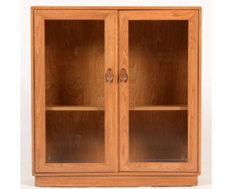 Ercol: an elm Windsor two-door bevelled glass bookcase, Model No. 810, 91 x 28 x 98cms high.