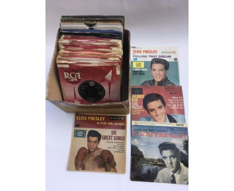 A box of Elvis Presley 7 inch singles and EPs.