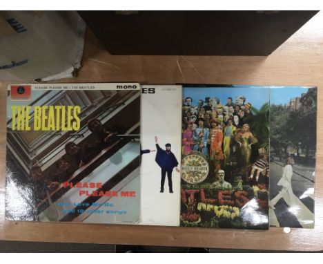 A record box of LPs by various artists including The Beatles, Bob Dylan, Creedence Clearwater Revival and others.