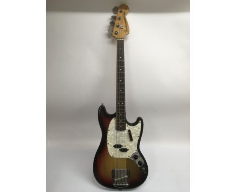 A circa 1973-74 USA Fender Mustang bass guitar in sunburst with white pearloid scratchplate. Comes supplied with a hard carry