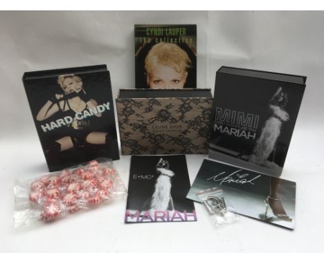 Four female pop star CD box sets comprising Madonna, Mariah Carey, Cyndi Lauper and Celine Dion, complete with inserts.