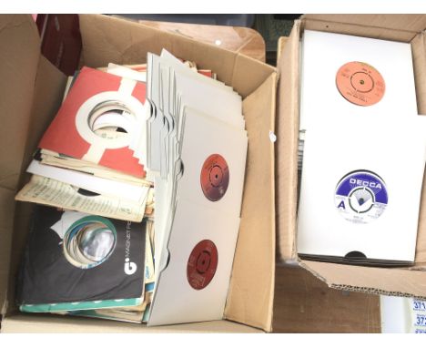 A box of various 7 inch singles including The Beatles, Bob Dylan, The Jam and others plus a bag of vintage record company sin