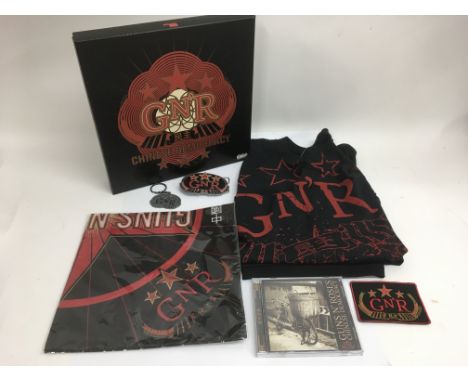 A Guns N Roses 'Chinese Democracy' CD box set complete with two T Shirts, belt buckle, sew on patch and other inserts.