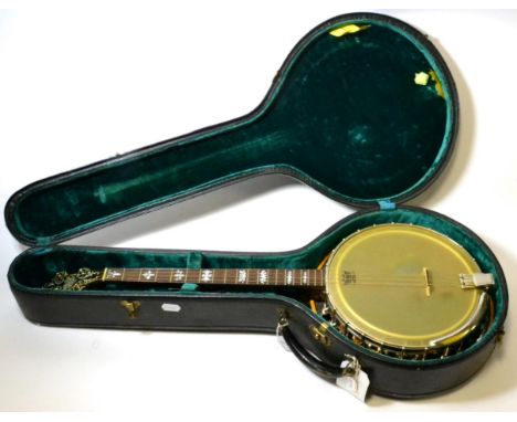 Banjo four string,11'' diameter, wooden resonator and hoop, ornate carving to heelblock and inlayed wood decoration to neck s
