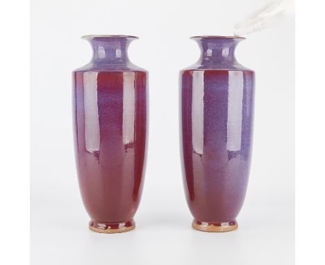 Pair of Chinese sang de boeuf flambe ceramic vases. With unglazed footrims. High shoulders with a flared rim.Height: 20 in x 