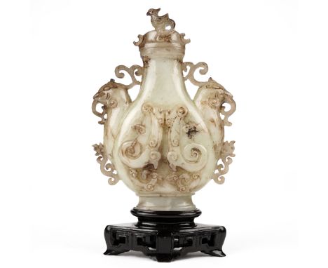20th century Chinese carved jade vase with beautiful scrolling foliate design flanked by two figural bird heads, surmounted b