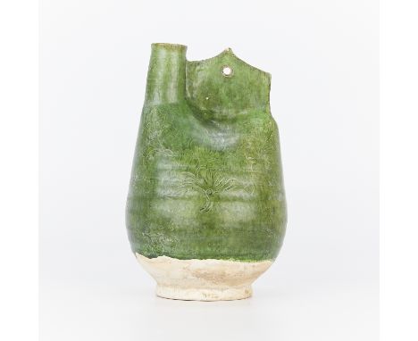 Chinese Liao dynasty ceramic ewer, modeled after a leather jug, with a single lug handle pierced with one hole. The sides wit