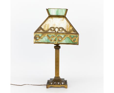 Arts and Crafts style lamp with a brass base and fittings and slag glass shade. The shade is broken in several places.Height: