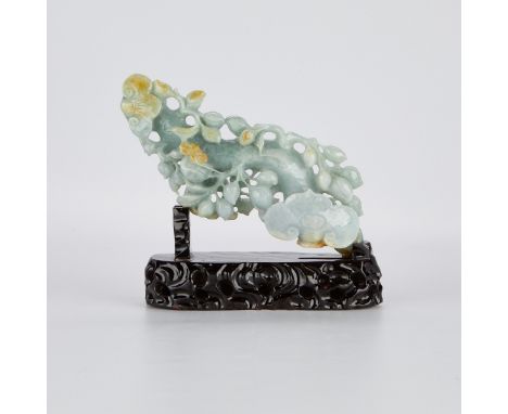 Chinese jade carving in the form of a ruyi scepter, carved of a celadon jade with pale russet inclusions. On a lacquered wood