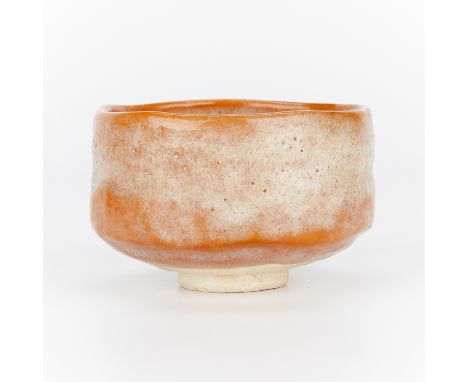 Japanese Raku ware chawan tea bowl with an orange glaze. Stamped along the underside. Prewar, early Showa, ca. 1926-1939. In 