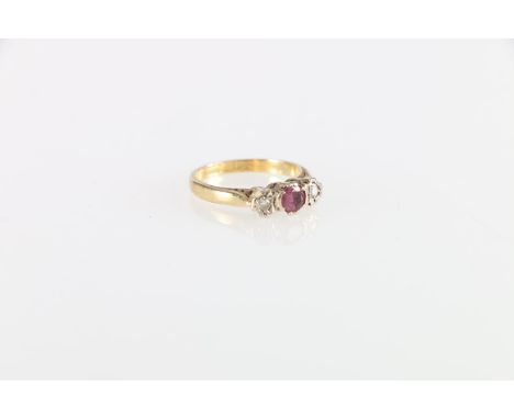 Unhallmarked yellow metal ruby and diamond three stone ring, size K, 3.2g 