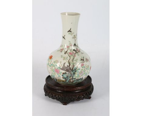 A Chinese early 20th century famille rose bottle vase nicely decorated with an eagle and a flock of birds perched amongst flo