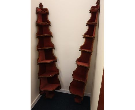 Pair of Victorian mahogany eight shelf corner etagere, lined with red velvet, 210 cm tall