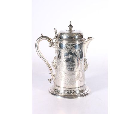 Victorian silver lidded ewer with applied lion masks, shell thumb piece and allover engraved decoration, the cartouche with i