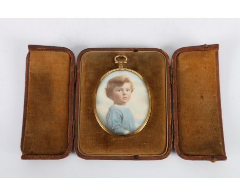Portrait miniature depicting a young boy, held within an oval gilt metal frame within a leather easel case, 7.5cm x 6cm 