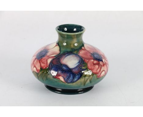 Moorcroft pottery squat vase decorated with anemone pattern on a blue green ground, WM painted signature to the base, 10cm ta