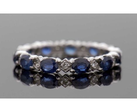 A sapphire and diamond eternity ring, the full hoop eternity ring set with alternating oval sapphires and single cut diamonds