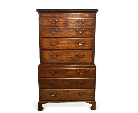 A George III mahogany chest on chest, the top section with a moulded and dental cornice over two short and three long drawers