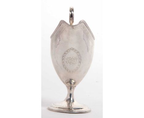 A George III Irish silver pedestal cream jug having a round body with tapering sides in helmet style, hand chased and engrave