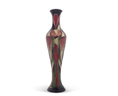 A Moorcroft vase with tubelined floral design, the base signed by Philip Gibson, 32cm high